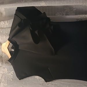Bodycon black dress sleeveless with ruffles on the right side it stretches.